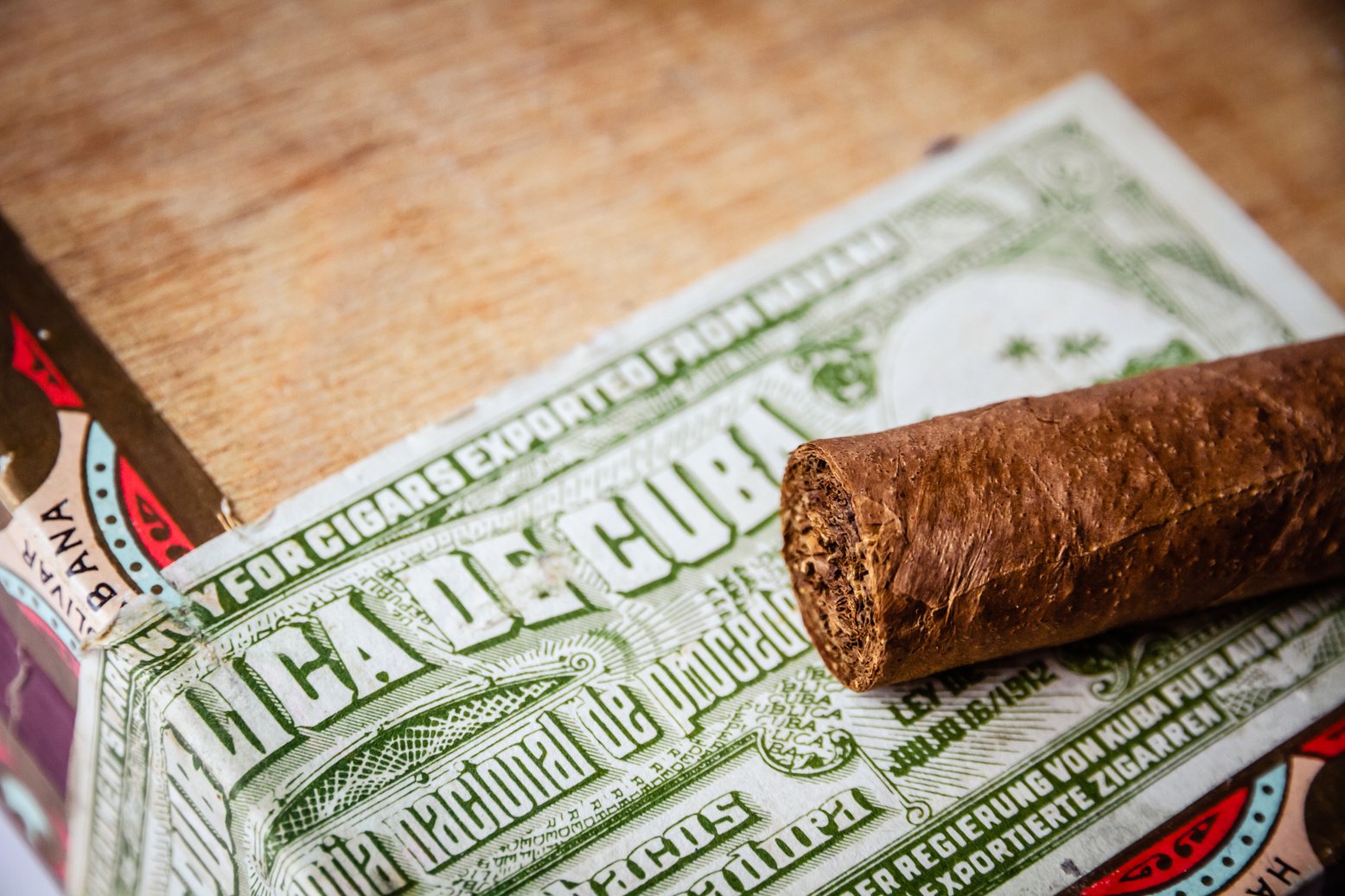 Cigar on Wooden Background with Cuban Official Tax Sticker